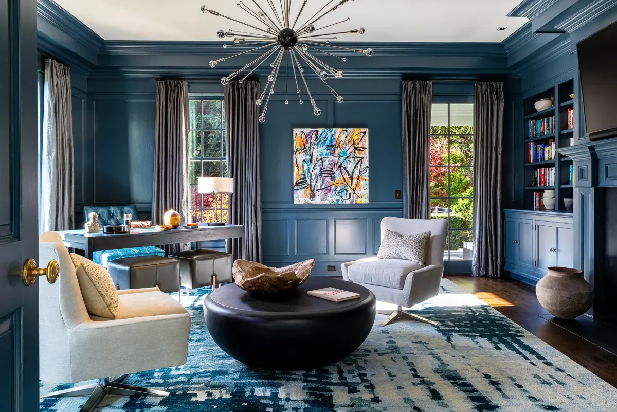 Home office in Greenwich, Connecticut with navy panelling and a single graffiti canvas, designed by Beth Krupa Interiors