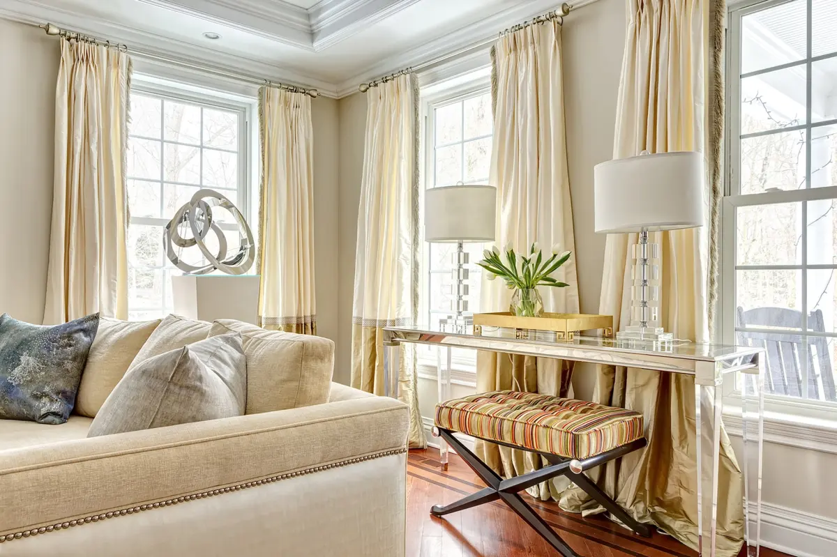 Living room in Westport, Connecticut with custom window treatments and a cream sofa, by Beth Krupa Interiors